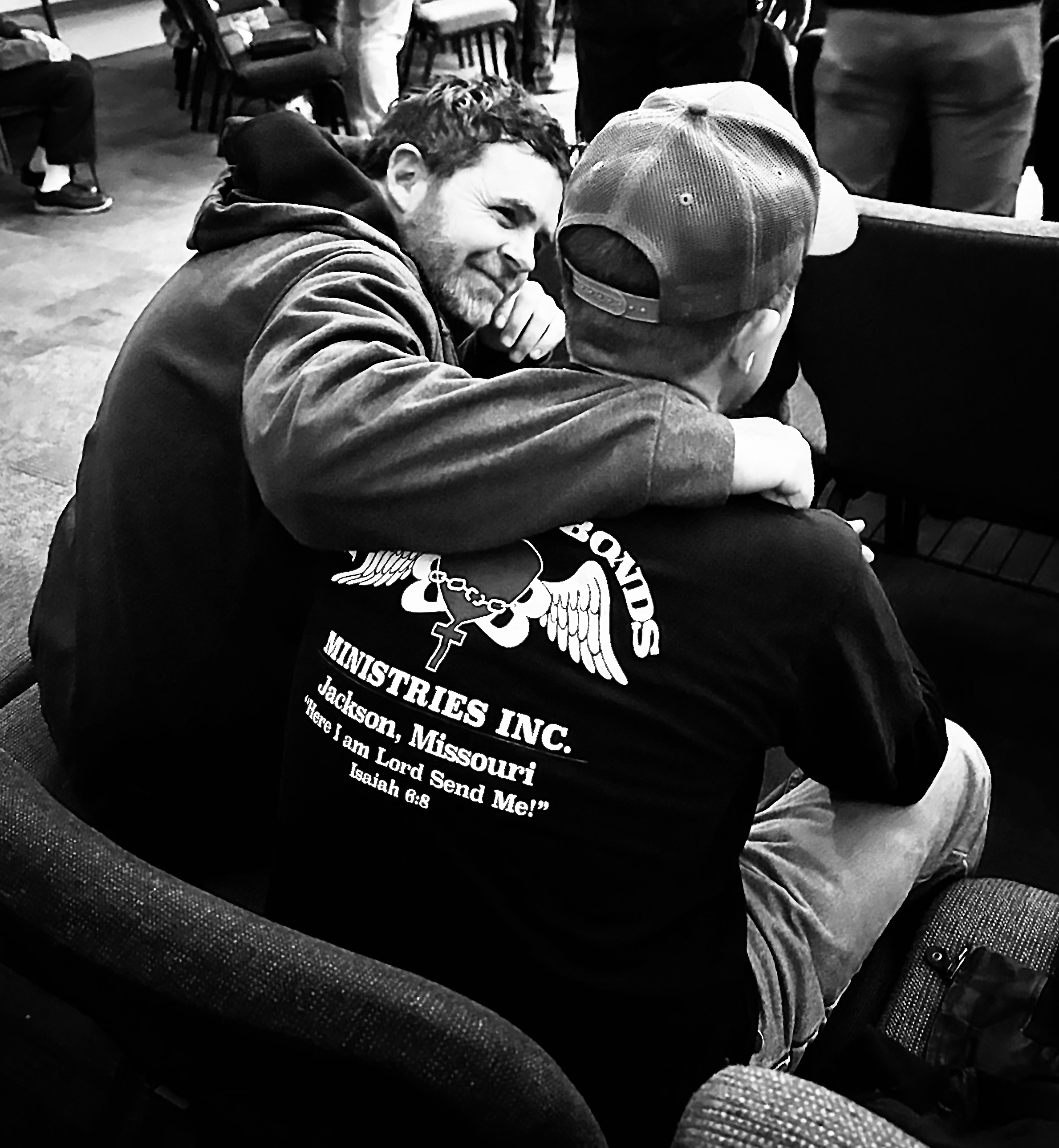 Men praying together at Breaking Bonds